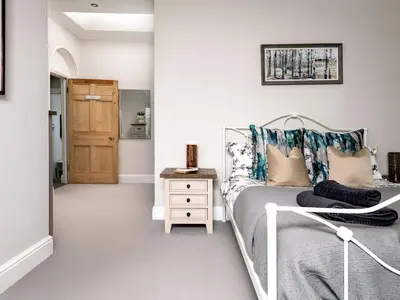 a bedroom with a bed and a wooden door at Fron Dderw in Bala