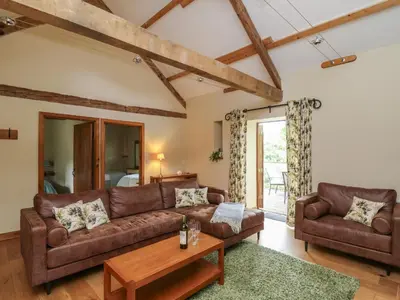 a living room with a couch and a table at Nant Glas in Llanwrda