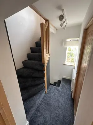a winding staircase in a small room with a stair case at Newtown Townhouse in Newtown