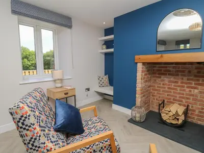 a living room with a couch and a fireplace at Rhiwmynach in Aberystwyth