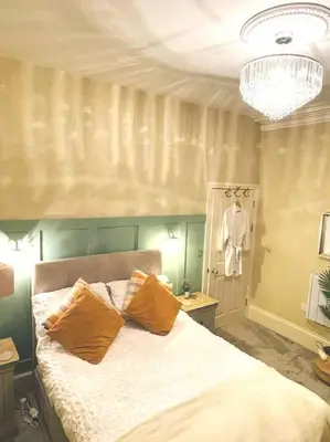 a bedroom with a bed with two pillows on it at Sunny View in Aberystwyth