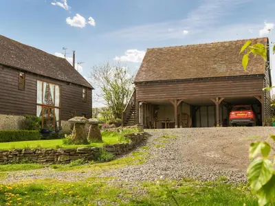 a barn with a car parked outside of it at The Loft At Callow Fold in Eaton