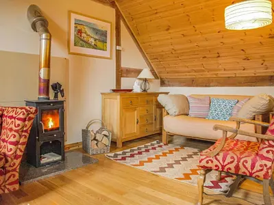 a living room with a fireplace and a couch at The Loft At Callow Fold in Eaton