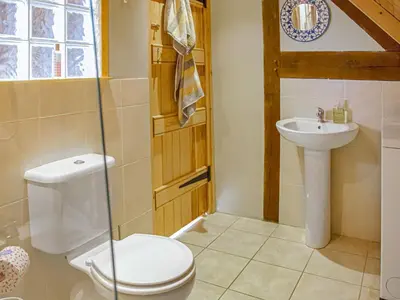 a bathroom with a toilet and a sink at The Loft At Callow Fold in Eaton