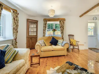 a living room with a couch and a table at Y Beudy in Capel Bangor