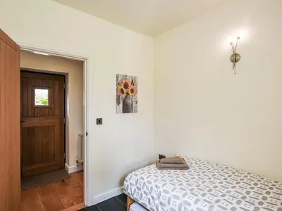 a bedroom with a bed and a wooden door at Orchard View in Minsterley