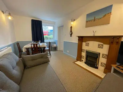 a living room with a couch and a fireplace at Glanywerydd Cottage in Barmouth
