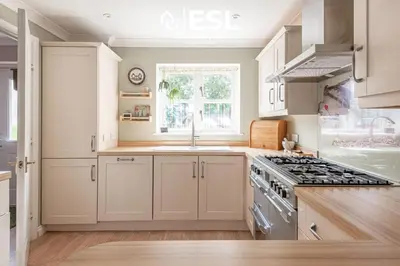 a kitchen with white cabinets and a stove at 4 Bedroom Townhouse 10mins walk from Shrewsbury Town Centre with Parking in Shrewsbury