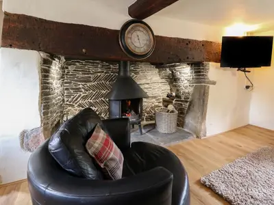 a leather chair in a living room with a fireplace at Penarth in Llandrindod Wells