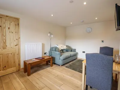 a living room with a couch and a table at Hen Blaid in Oswestry