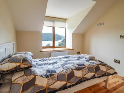 a bedroom with a bed and a window at Llety Dewi in Oswestry