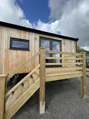 a wooden house with a wooden ramp in front of it at Cwtch Cader Shepherds Hut in Llanelltyd