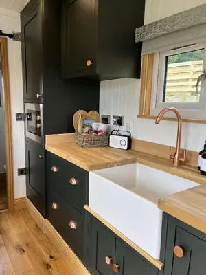 a kitchen with a sink and a counter top at Cwtch Cader Shepherds Hut in Llanelltyd