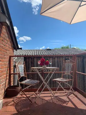 a table and two chairs on a balcony at The Hayloft in Hereford