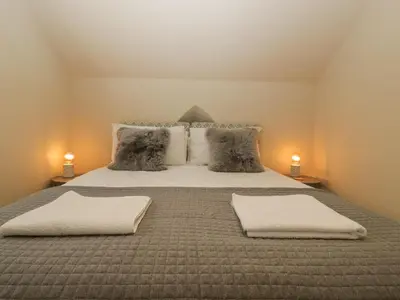 a bedroom with a large bed with two pillows at The Old Chapel in Hereford