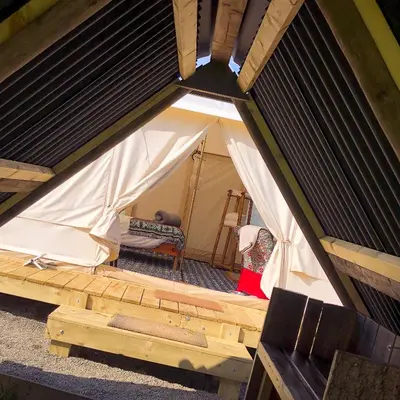 an overhead view of a tent with a bench at Tinker the Bell Tent at Pentref Luxury Camping in Penuwch