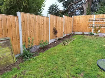 a fence in a yard with a garden at Clematis Cottage in Shrewsbury
