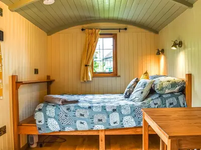 a bedroom with a bed and a window at Bechan Brook Hut in Bettws Cedewain
