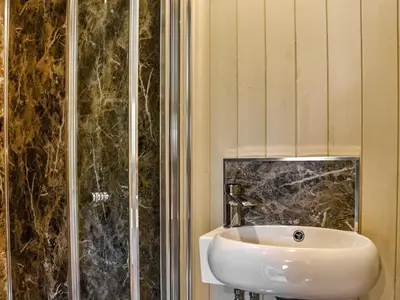 a bathroom with a sink and a shower at Bechan Brook Hut in Bettws Cedewain