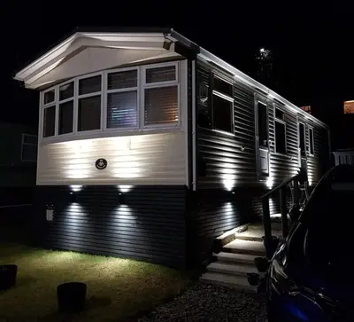 a trailer parked in front of a house at night at Wonderful 2 bedroom mobile home in Aberystwyth