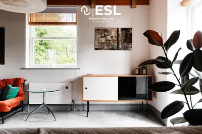 a living room with a tv and a table at 3 Bedroom House - Overlooking River - Shrewsbury Town Centre in Shrewsbury