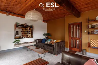 a living room with a couch and a table at 3 Bedroom House - Overlooking River - Shrewsbury Town Centre in Shrewsbury
