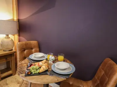 a table with a plate of food and drinks on it at Daffodil in Welshpool