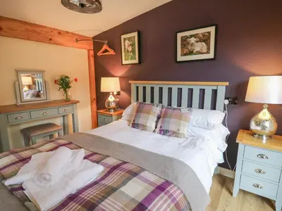 a bedroom with a bed with two pillows on it at Daffodil in Welshpool