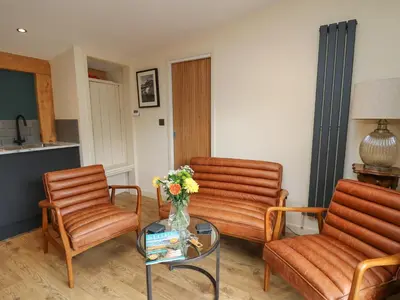 a living room with two chairs and a table at Celyn in Welshpool