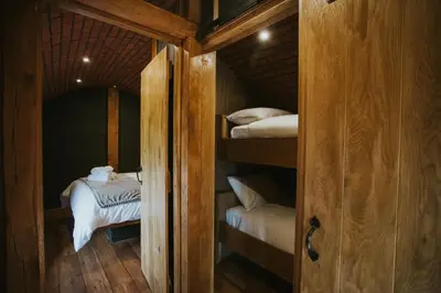 a small room with bunk beds in a cabin at Otters View in Rhayader