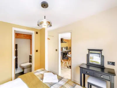 a bedroom with a bed and a television on a table at Rhosyn - Uk40260 in Llangadfan