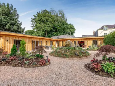 an exterior view of a house with a garden at Celyn - Uk40258 in Llangadfan