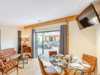 a living room with a table and chairs and a television at Celyn - Uk40258 in Llangadfan