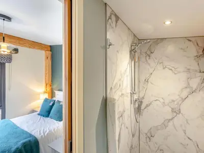 a master bathroom with a shower and a bed at Celyn - Uk40258 in Llangadfan