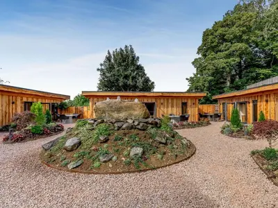 a garden with a rock in front of a building at Pansi - Uk40263 in Llangadfan