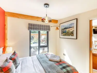 a bedroom with a bed and a window at Pansi - Uk40263 in Llangadfan