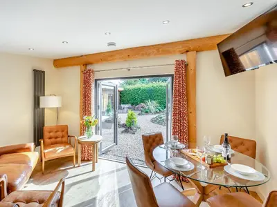 a living room with a table and chairs at Fioled - Uk40267 in Llangadfan