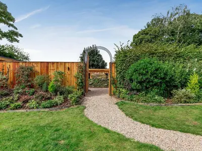 a gate in a garden with a fence at Daffodil - Uk40266 in Llangadfan