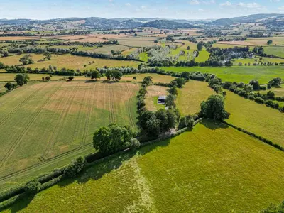 an aerial view of a green field with trees at Jacobs Plock in Leintwardine