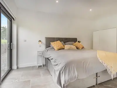 a white bedroom with a bed with pillows on it at Jacobs Plock in Leintwardine