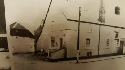 an old black and white photo of a building at Curly Tail Accommodation in Bishops Castle