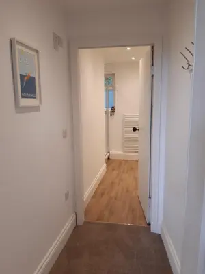 a hallway with white walls and wooden floors at Seasalt Loft in Barmouth