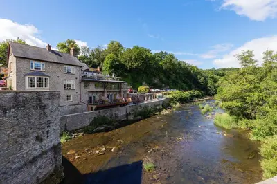 a river with a building on the side of it at Ludlow Townhouse in Ludlow