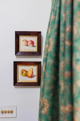 three pictures of fruit in wooden frames on a wall at Ludlow Townhouse in Ludlow