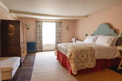 a bedroom with a large bed and a window at Ludlow Townhouse in Ludlow