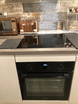 a kitchen with a stove top oven in a kitchen at Ty Cwtch in Dolgellau