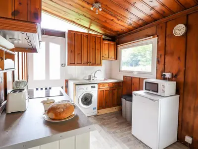 a kitchen with a loaf of bread on a counter at Chalet 2 in Machynlleth
