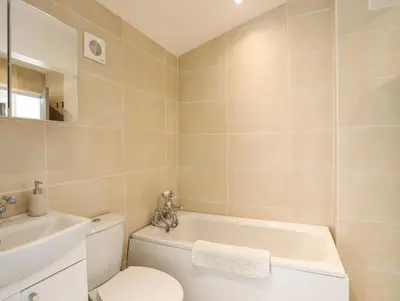 a bathroom with a toilet and a sink at Bryn Y Mor in Tywyn