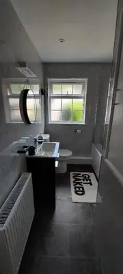 a bathroom with a white sink and a mirror at Modern Town House in Mid Wales in Knighton