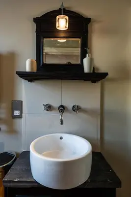 a bathroom with a white sink on a counter at The New White Lion in Llandovery